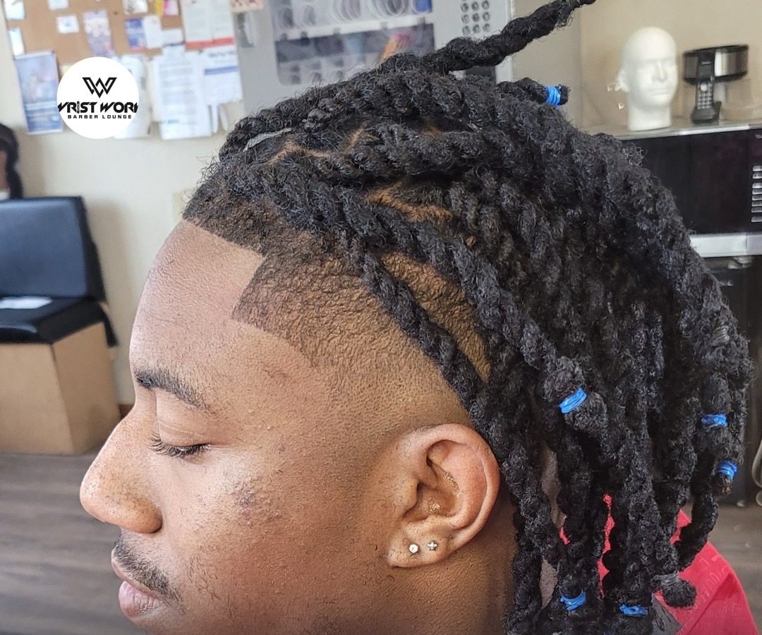 Two-strand twists with a sharp taper fade and razor line-up, cut at Wrist Work Barber Lounge